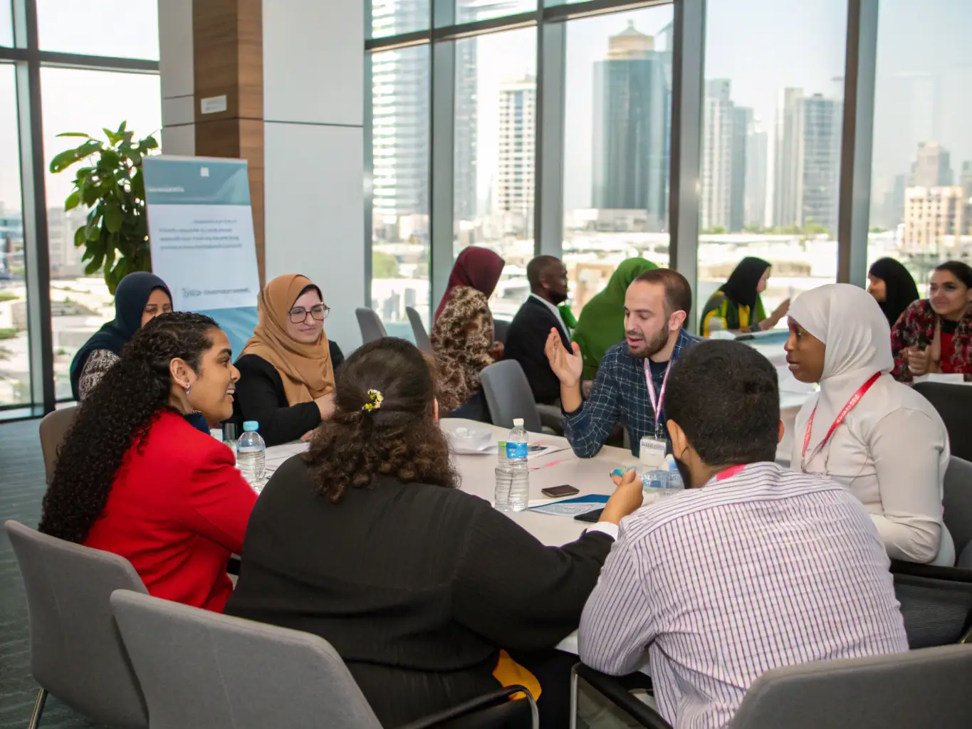 A diverse group of London residents participating in a community meeting, discussing the benefits and governance of their local efiWifi network.